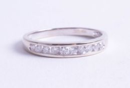 An 18ct white gold and diamond set half band eternity ring, size R.