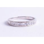 An 18ct white gold and diamond set half band eternity ring, size R.