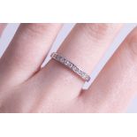 An 18ct diamond set half band eternity ring, size M.