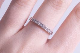 An 18ct diamond set half band eternity ring, size M.