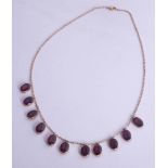 An Edwardian gold and garnet necklace.