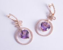 An impressive pair of 14ct amethyst and diamond set earrings.