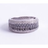A 14ct black and white diamond set dress ring, size P/Q.