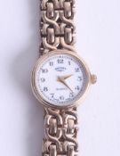A ladies 9ct gold wristwatch with original box and purchase guarantee, dated 28th October 1994.
