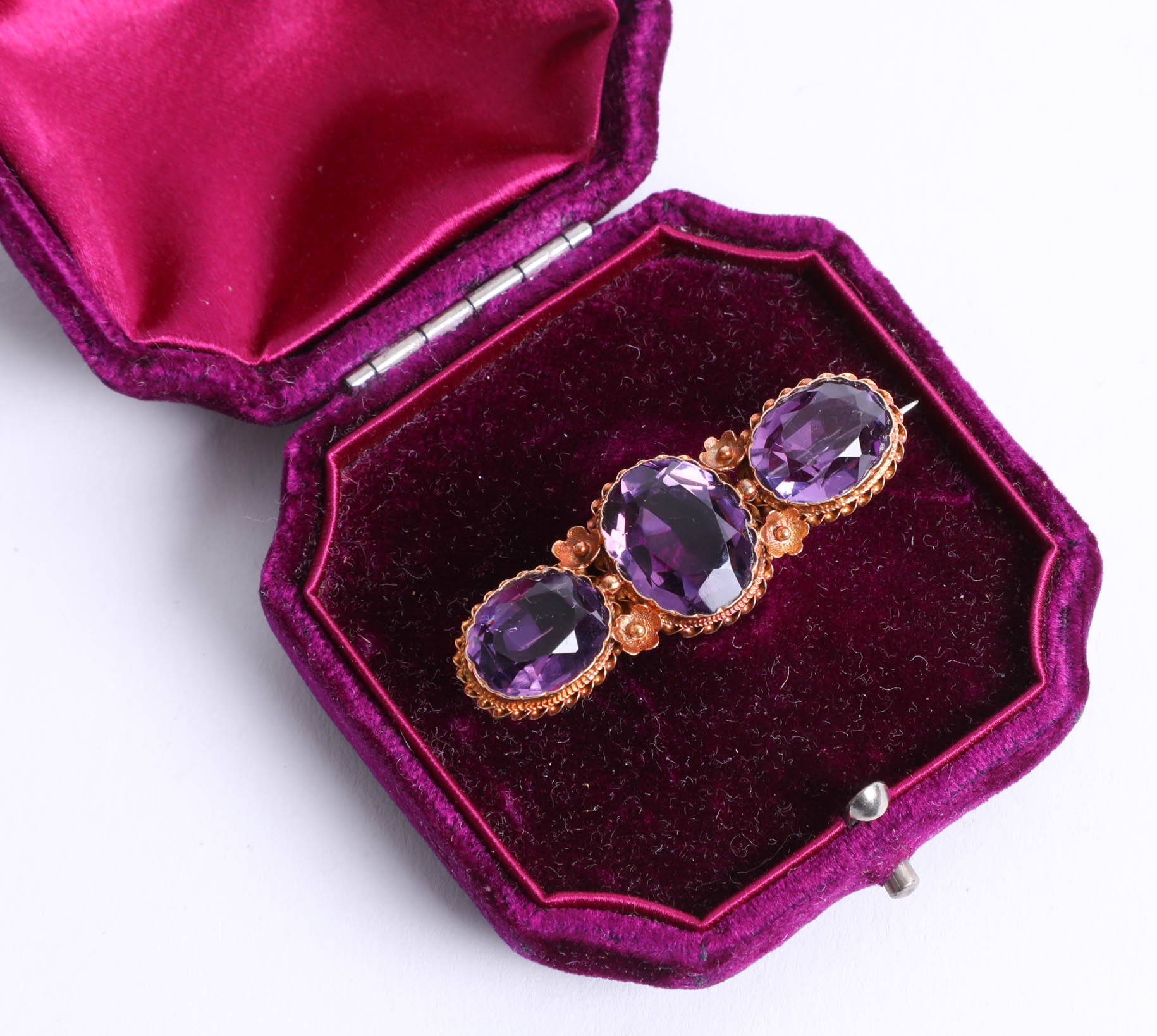 A 15ct amethyst three stone bar brooch, 5.50g. - Image 2 of 2