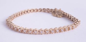 A diamond set tennis bracelet in yellow gold, approximately 1.50ct.