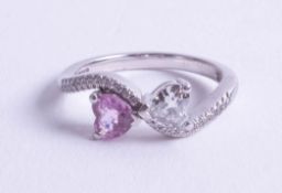 An 18ct heart shaped diamond and pink sapphire ring, size M.