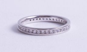 A platinum and diamond set eternity ring, size M.