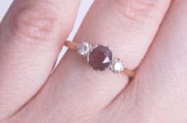 An 18ct ruby and diamond three stone ring size K, being sold to raise money for Dog Rescue Cyprus.