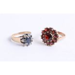 A 9ct and garnet set cluster ring, together with a 9ct sapphire and diamond cluster ring, 8.30g (2)