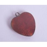 A gold enamel heart-shaped pendant.