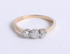 An 18ct diamond and platinum three stone ring, set with old cut diamonds, size K.