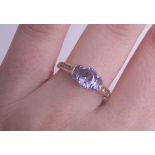 A 9ct three stone tanzanite ring set with further diamonds to the shoulders (Fraser Hart), size N.