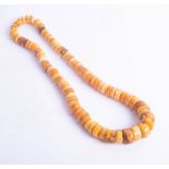 An amber bead necklace, approx 80cm.