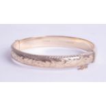 A 9ct gold bangle, approx 10.60g.