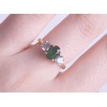 A fine 18ct emerald and diamond three stone ring, size L.