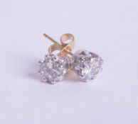 A pair of diamond stud earrings, set in white and yellow gold, approx 1ct.