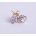 A pair of diamond stud earrings, set in white and yellow gold, approx 1ct.