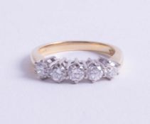 An 18ct diamond set five stone ring, size N.