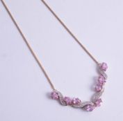 A stylish 14ct and pink sapphire and diamond set pendant.