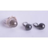 Black pearl and diamond ring, size P together with similar earrings.