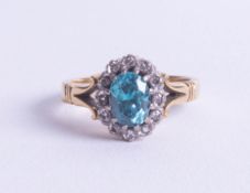 An 18ct blue zircon? and diamond cluster ring, size N.