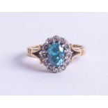 An 18ct blue zircon? and diamond cluster ring, size N.