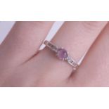 A 14ct white gold ring set with a pink sapphire, size N.