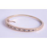 A 9ct sapphire and diamond set bangle, approx 14.20g.