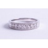 An 18ct white gold and diamond set fancy eternity ring, size M.