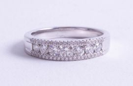 An 18ct white gold and diamond set fancy eternity ring, size M.
