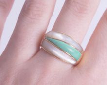 An 18ct mother of pearl and green domed ring, size Q, approx 10.60g.