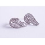 A pair of 18ct white gold contemporary, stylish diamond set earrings.