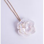 An 18ct yellow gold chain set with mother of pearl flower pendant and brooch.