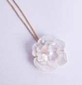 An 18ct yellow gold chain set with mother of pearl flower pendant and brooch.