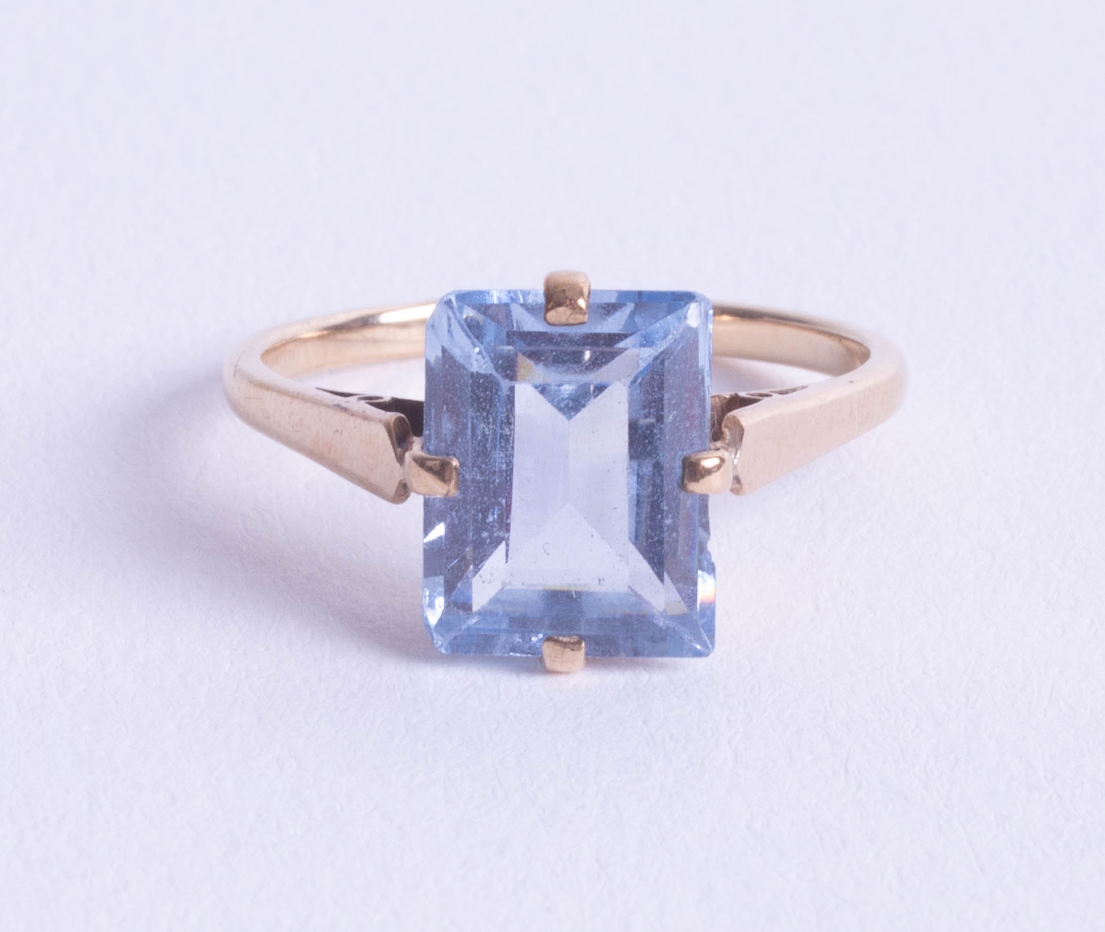 A 9ct dress ring set with blue topaz, emerald cut stone, size O.