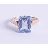 A 9ct dress ring set with blue topaz, emerald cut stone, size O.