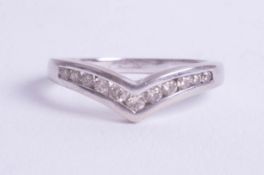 A 9ct white gold and diamond channel set wishbone ring, size K.