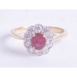 A good 18ct ruby and diamond cluster ring, ring size T.