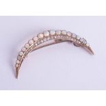 A antique opal and diamond set half crescent style brooch with safety chain, set with nineteen white