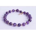 An amethyst and gold set bead bracelet, marked '750'.