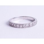 A platinum half band and diamond set eternity ring, set with fifteen diamonds, size N.
