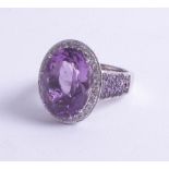 A large 18ct amethyst and diamond set ring, size S.