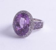 A large 18ct amethyst and diamond set ring, size S.