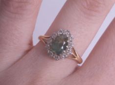 An 18ct green stone cluster ring, possibly a tourmaline, size O.