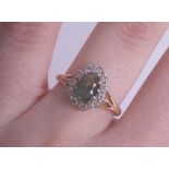 An 18ct green stone cluster ring, possibly a tourmaline, size O.