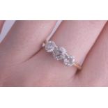 An 18ct three stone diamond ring, the centre stone approximately .50 carats, size N, being sold to