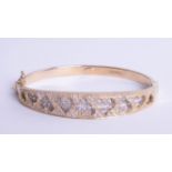 A 9ct bangle with heart design with diamonds, 20.30g.