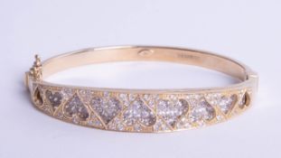 A 9ct bangle with heart design with diamonds, 20.30g.