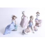 Lladro, a child sat upon a puppy and a dancing child, together with two Nao figures (4).